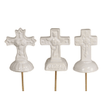 Set of three small white cross ornaments on picks with different embossed designs.