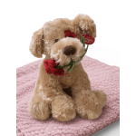 Plush dog holding a red rose on a pink knitted blanket