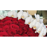 Red roses with white orchids arranged in a car interior