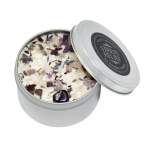 Tin candle with crystal and dried flower petals on top