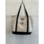 Canvas tote bag with black straps and printed text