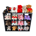 Shelf of teddy bears holding heart-shaped pillows
