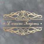 Gold floral boutique logo on a dark gray background