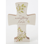 Decorative cross plaque with floral print and the words "do everything in love"