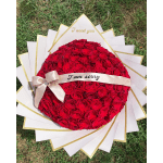 Heart-shaped bouquet of red roses with a ribbon and message band