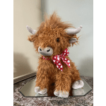 Plush brown highland cow with a red heart-patterned bow
