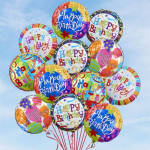 Cluster of colorful birthday balloons against a blue sky
