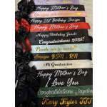 Stack of personalized satin ribbons with bows and printed messages