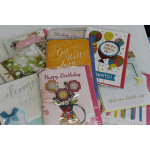 Assorted greeting cards with birthday, get well, and baby themes