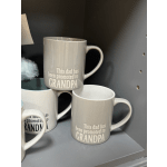 Gray ceramic mugs with the text "This dad has been promoted to GRANDPA"