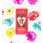 Red boxed chocolate bar with heart-shaped LOVE design surrounded by colorful daisies.