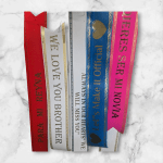 Five decorative ribbon bookmarks with romantic messages