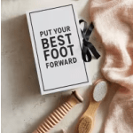 Gift box with a card reading "Put Your Best Foot Forward" and a pair of foot brushes