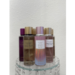 Assorted Victoria's Secret fragrance mist bottles on a glass shelf