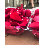 Tray of red rose petals in clear plastic containers