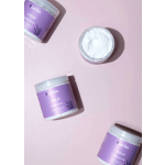 Purple jars of whipped scrub on a pink background