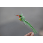 Small decorative hummingbird figurine with green wings and a red beak