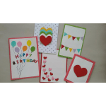 Assorted handmade greeting cards with balloons, hearts, and bunting.
