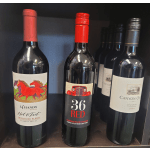 Several bottles of red wine displayed on a shelf