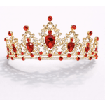 Gold tiara with red and clear rhinestones on a white background