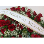 Red rose arrangement with a white ribbon reading personal message