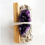 Purple crystal cluster tied to a bundle of dried sage and wood