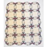 Cream quilt with a repeating oval chain pattern in muted red, blue, and gray