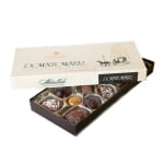 Open box of assorted chocolates with a branded lid