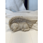 Small angel-wing dog figurine with memorial text on a bed
