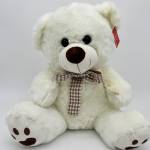 White teddy bear with a plaid bow tie and red tag