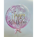 Clear balloon with pink confetti and gold "Happy Birthday" text