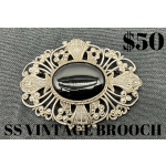 Decorative silver brooch with a black oval stone