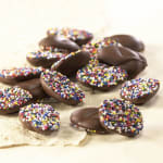 Chocolate-covered treats topped with colorful sprinkles on burlap