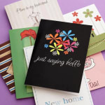 Stack of greeting cards with floral designs and handwritten messages