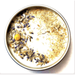 Round tin candle topped with dried flower petals