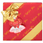 Red gift box with a gold bow and Lindor chocolates