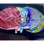 Stack of colorful birthday foil balloons with heart and candle designs