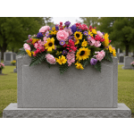 Colorful floral arrangement draped over a gray gravestone