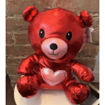 Red teddy bear plush with a pink heart on its chest