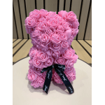 Pink rose-shaped teddy bear with a black ribbon bow