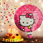 Hello Kitty birthday balloon with a cake and candles in the background