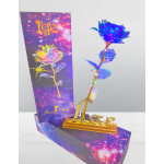 Decorative blue artificial rose on a gold stand with a gift box