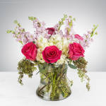 Pink roses and white hydrangeas in a clear glass vase