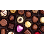Assorted chocolates in a gift box, including foil-wrapped pieces