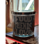 Glass candle jar with "Food Friends Love" text on the front