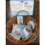 Basket of packaged guardian angel tokens with a matching display card