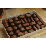 Box of assorted chocolate candies in paper cups