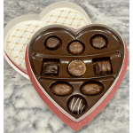 Heart-shaped box of assorted chocolates on a marble surface