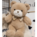 Plush teddy bear with a plaid bow tie