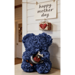 Blue teddy bear made of roses with a small gift box and Mother's Day sign